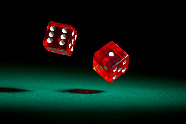 Live dealer dealing baccarat cards under multiple cameras
